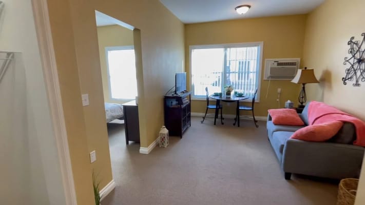 Bright, cozy resident room with a small dining area