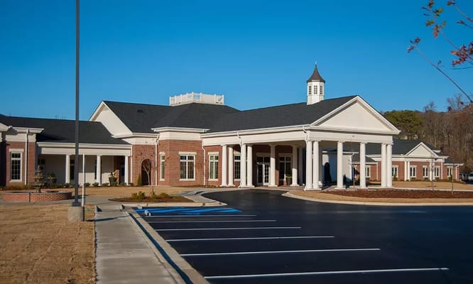 Exterior view of a senior living facility with parking