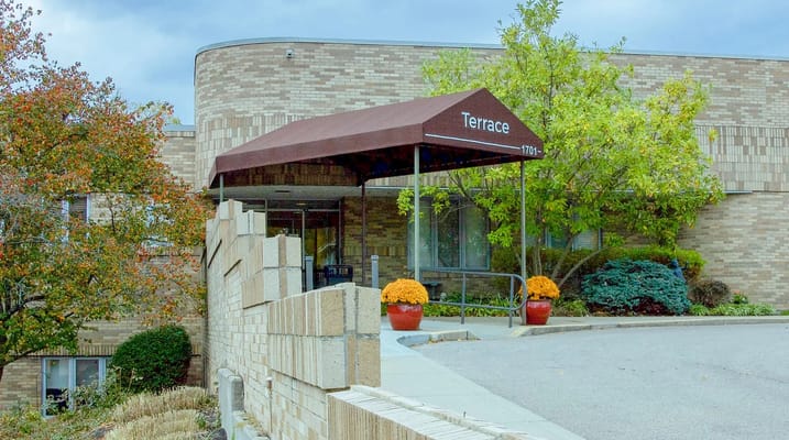 Entrance of the facility with awning and landscaping