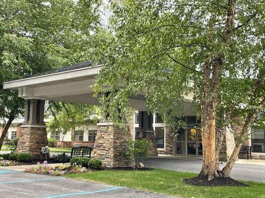 Entrance of the Peregrine Senior Living facility with greenery