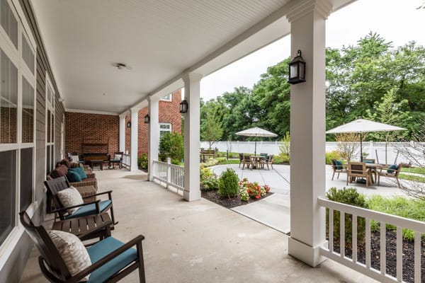 Covered porch with seating overlooking the garden area.