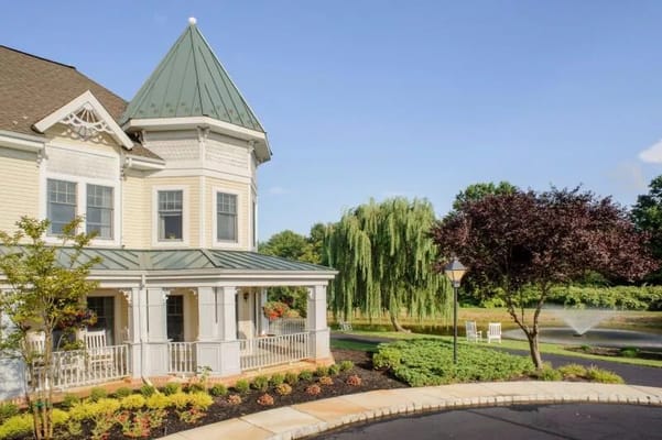 Exterior view of a senior living facility with gardens
