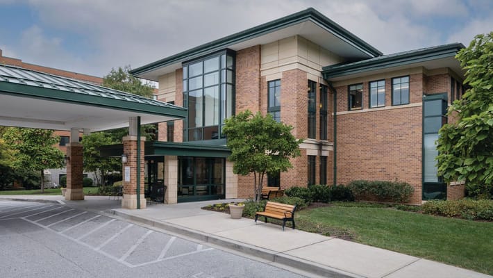Exterior view of a senior living facility with greenery