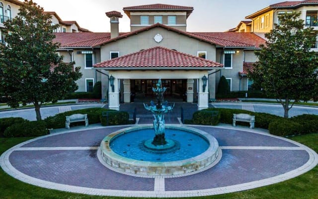 Exterior view of the facility entrance with fountain