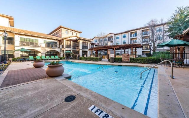Swimming pool area with lounge chairs and landscaping