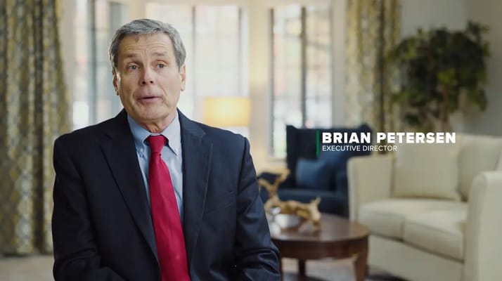 Executive Director speaking in a cozy interior setting