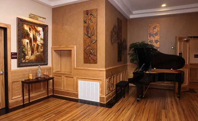Interior lobby area with a piano and artwork