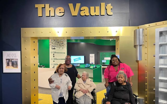 Residents and staff smiling together in a vibrant indoor space