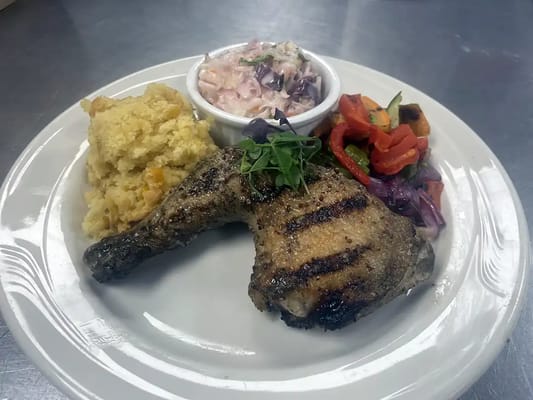 A beautifully plated meal with chicken and sides