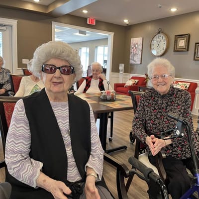 Two smiling residents in a common area