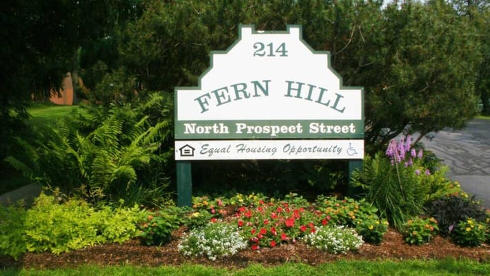Sign for Fern Hill Apartments with flowers