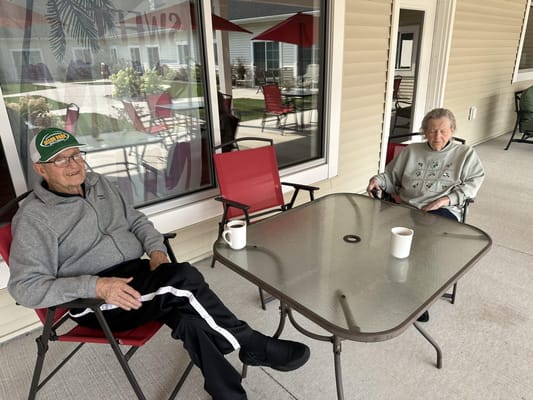 Residents enjoying coffee in outdoor seating area