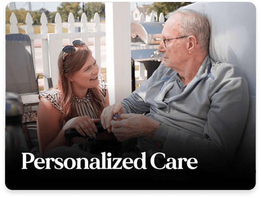Resident and staff member enjoying a conversation in an outdoor setting