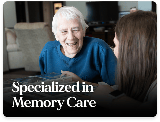 A resident smiling during a conversation with staff