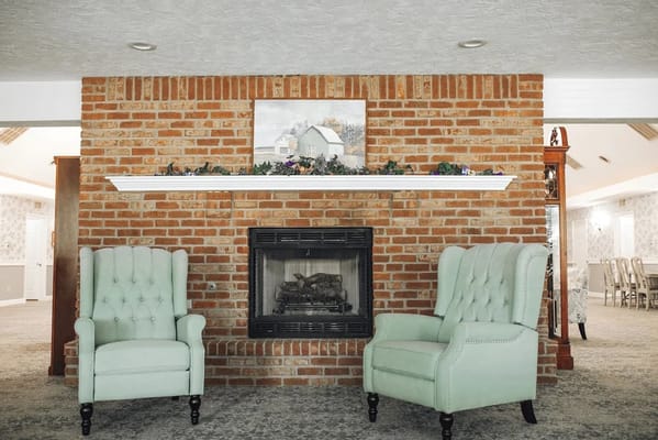 Cozy seating area with a fireplace in a common room