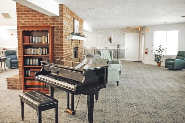 An inviting common area with a piano and seating