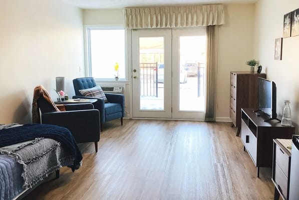 Cozy resident room with seating and natural light