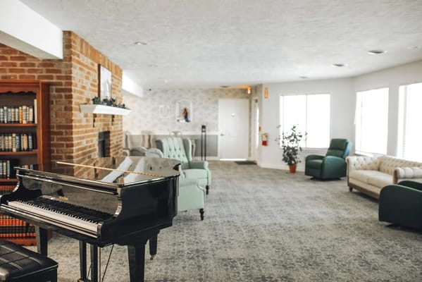 Interior view of a cozy common area with a piano