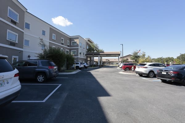 Exterior view of the Discovery Village At Deerwood facility with parking.