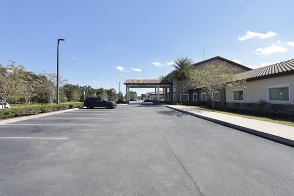 Exterior view of the facility entrance and parking area
