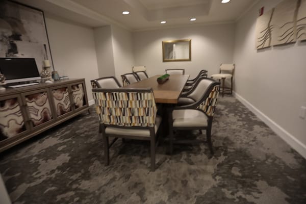Dining room featuring a long table and patterned chairs