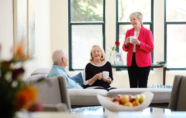 Residents enjoying conversation in a cozy common area