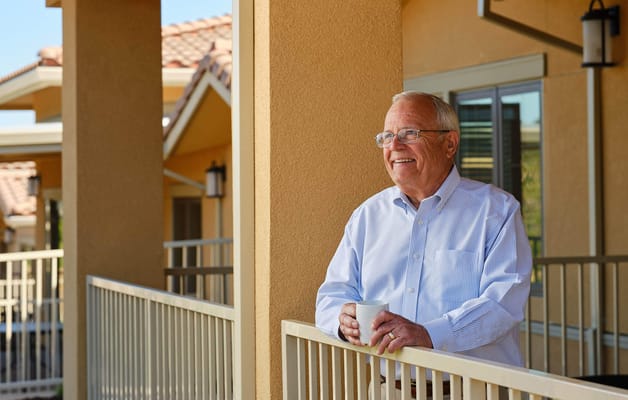 Resident enjoying time on the balcony with a coffee