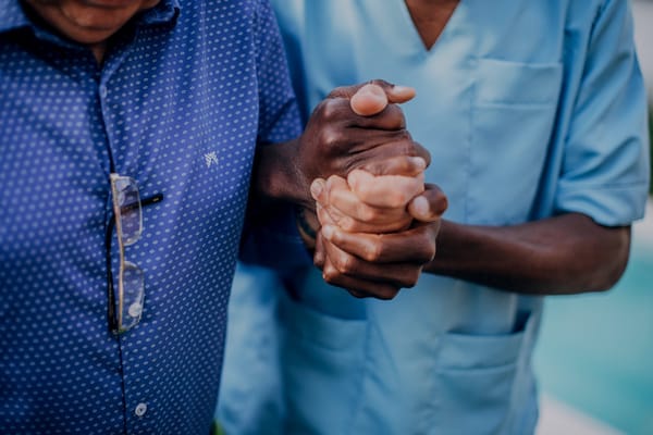 Care staff assisting a resident outdoors