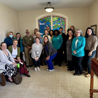 Staff and residents posing together in a common area