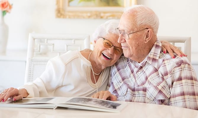 Two residents enjoying time together in a bright room