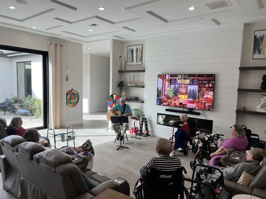 Residents participating in a music activity in a bright common area
