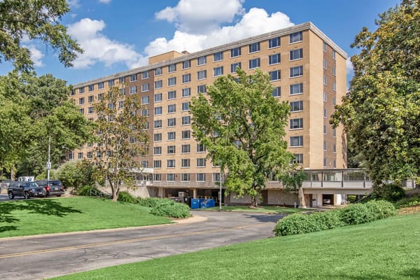 Exterior view of a senior living facility surrounded by greenery
