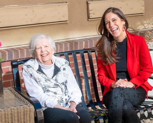 A resident and staff member enjoying time outdoors