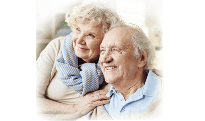 Two smiling seniors enjoying each other's company