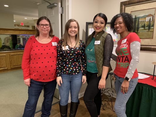 Staff members posing together in a common area