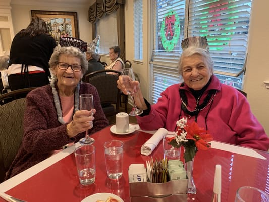 Residents celebrating with drinks at a dining table