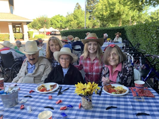 Residents enjoying a meal outdoors in a festive setting