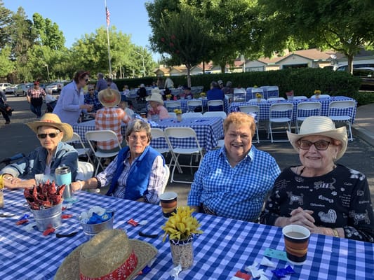 Residents enjoying a community outdoor event at tables