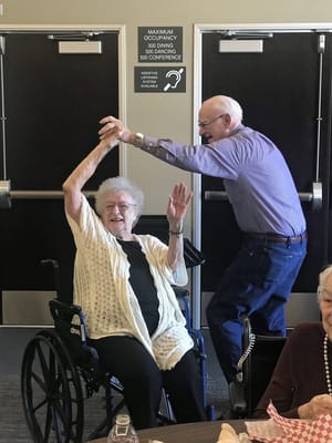 Residents dancing and enjoying a lively activity in a common area