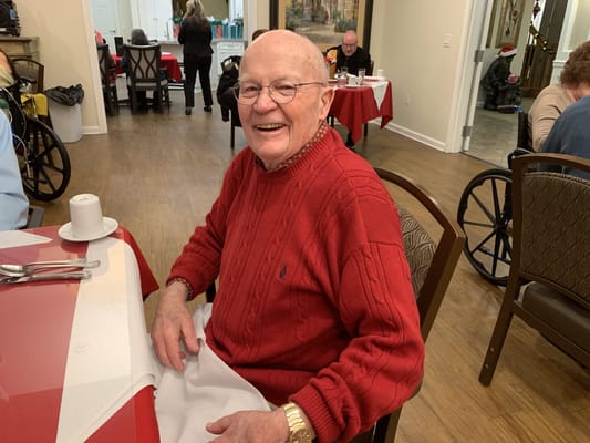 Smiling resident in a dining room setting