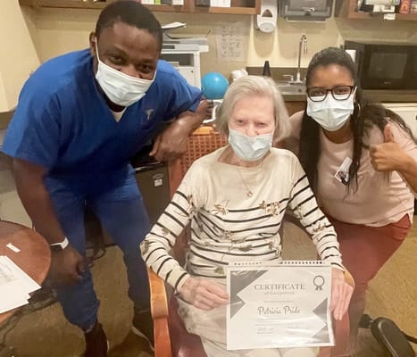 Staff and residents celebrating an achievement indoors