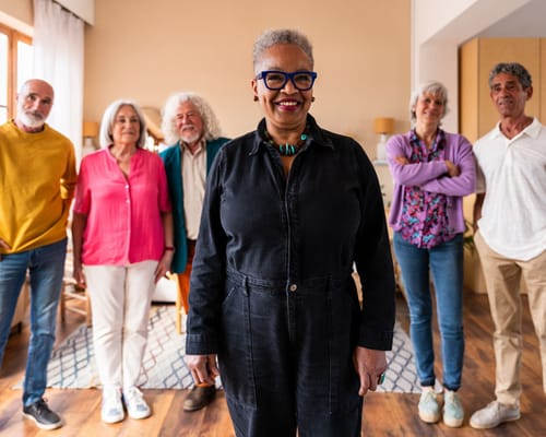 A diverse group of residents posing together in a common area