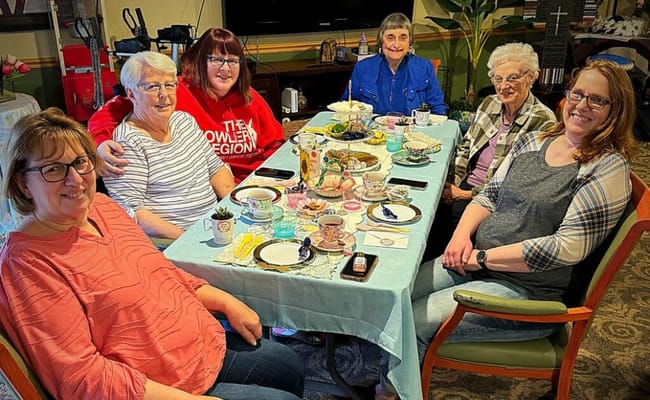 Residents and staff enjoying a tea party together