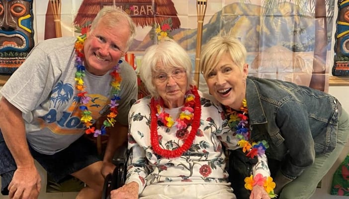 Residents celebrating at a themed event with leis