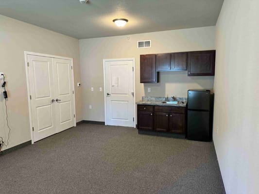 Interior view of a resident room with kitchenette