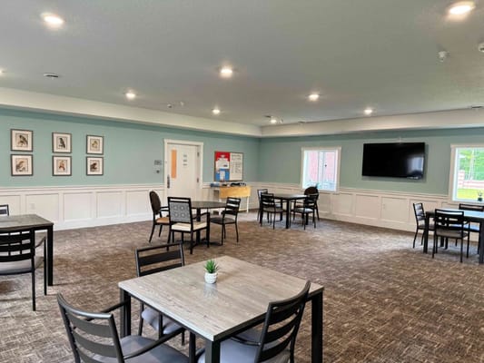 Bright and spacious common area with tables and chairs