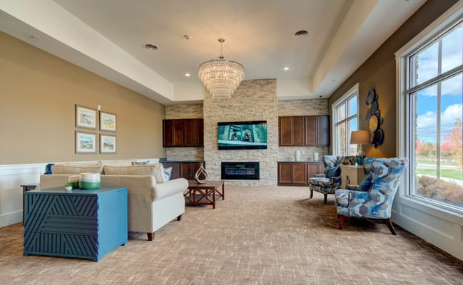 Common area lounge with sofas and a chandelier