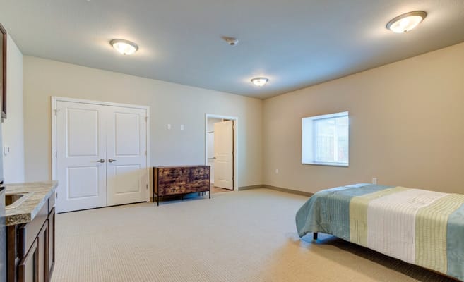 A bright, empty resident room with a window