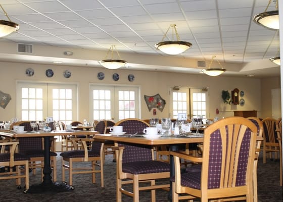 A dining room setup with tables and chairs