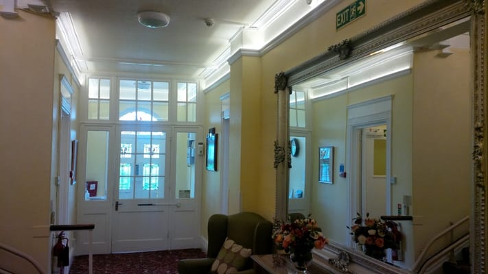 Interior hallway with decorative mirrors and seating
